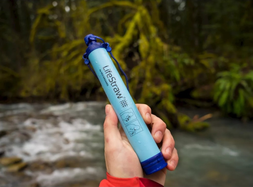 holding LifeStraw outdoors