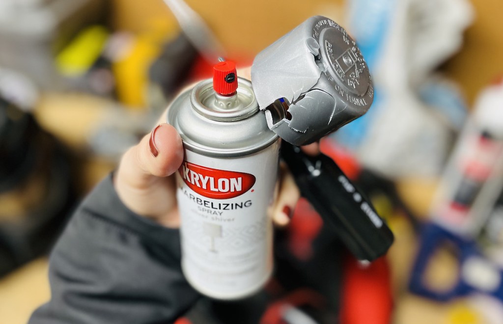 hand holding a can of broken marble spray paint