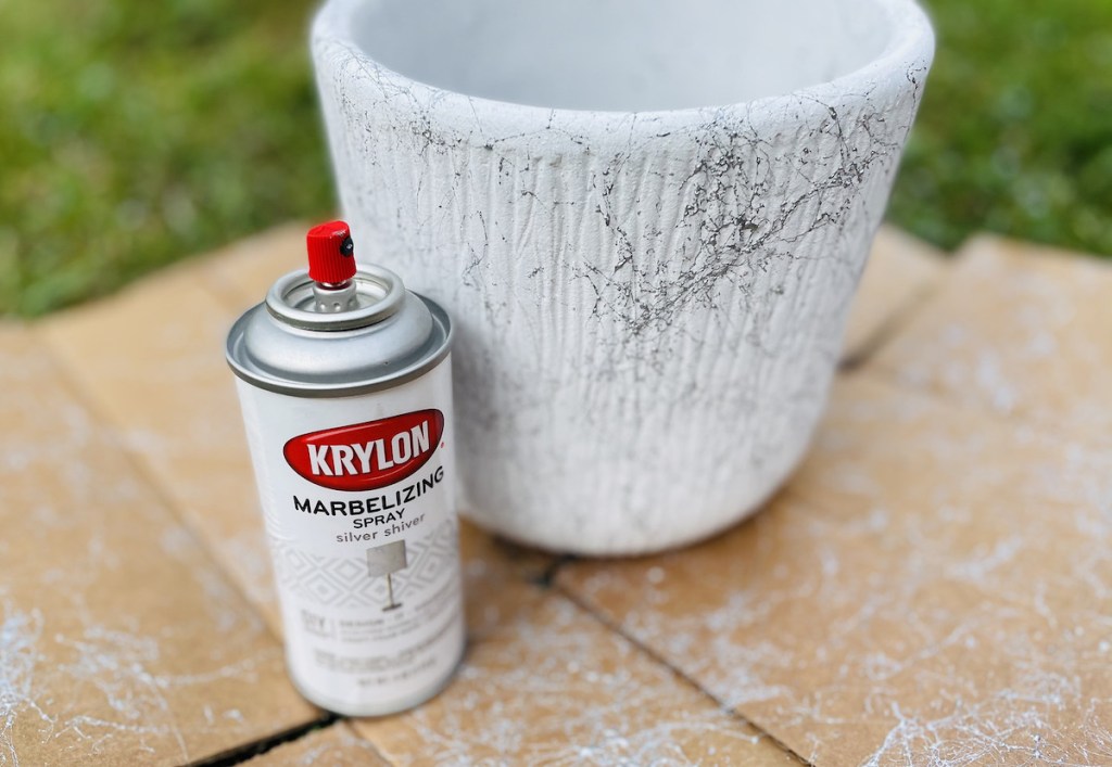 white planter next to marble spray paint