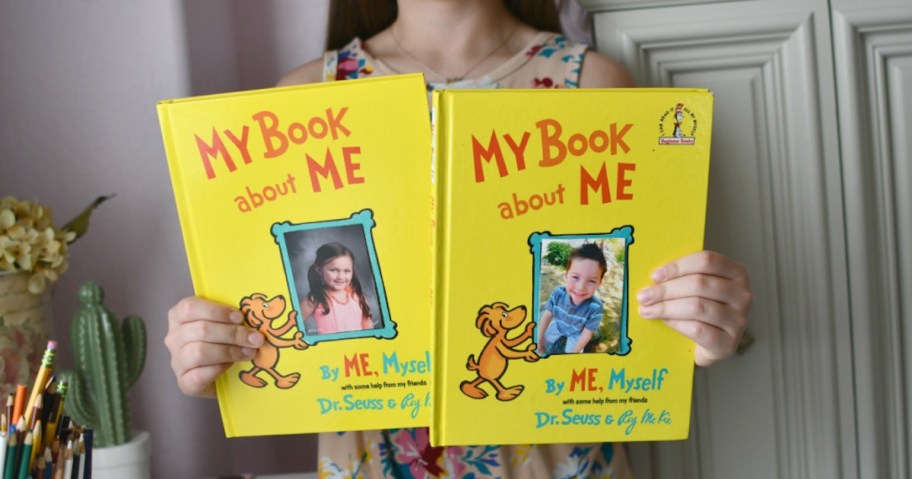 girl holding two my book about me dr suess books