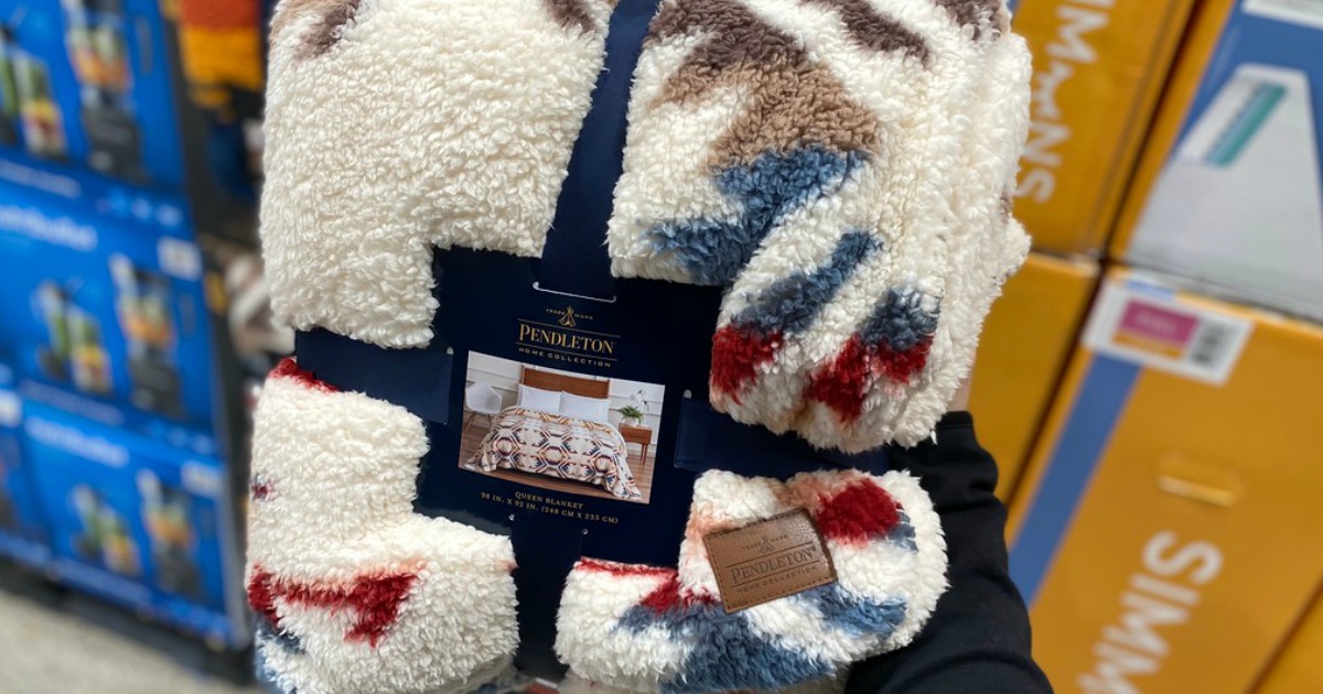 pendleton cozy sherpa blanket in packaging beind held in store