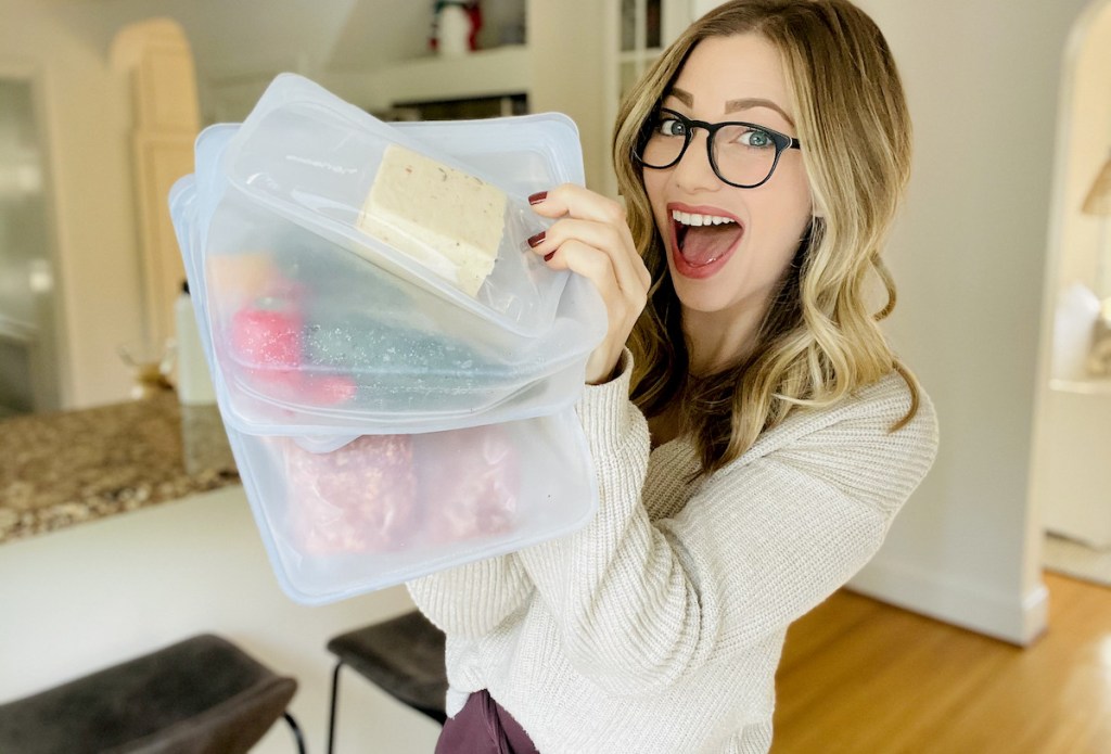 woman holding a bunch of stasher bags