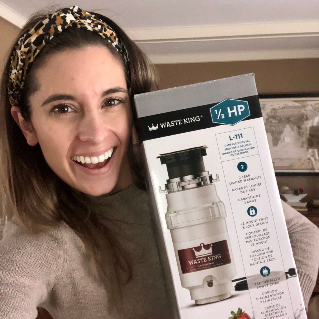 woman holding garbage disposal in box