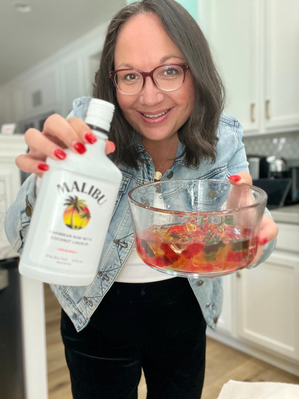 woman holding gummy bears and malibu coconut rum