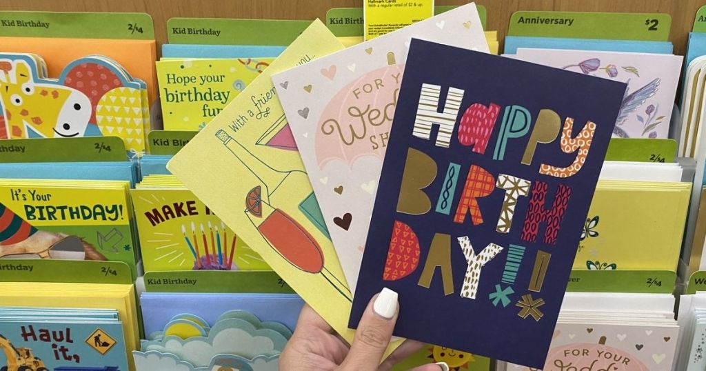 woman holding 3 Hallmark Cards