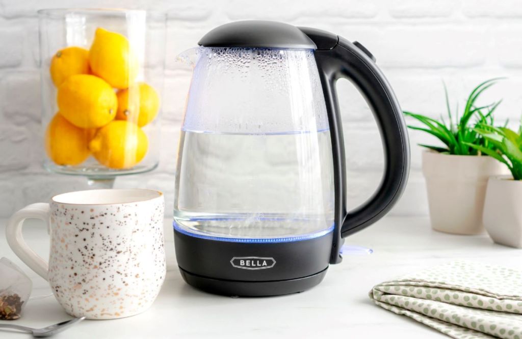 glass kettle with a mug next to it