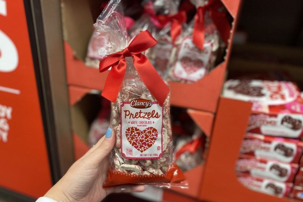 hand holding Clancy's White or Pink Chocolate Covered Valentine Pretzel Hearts