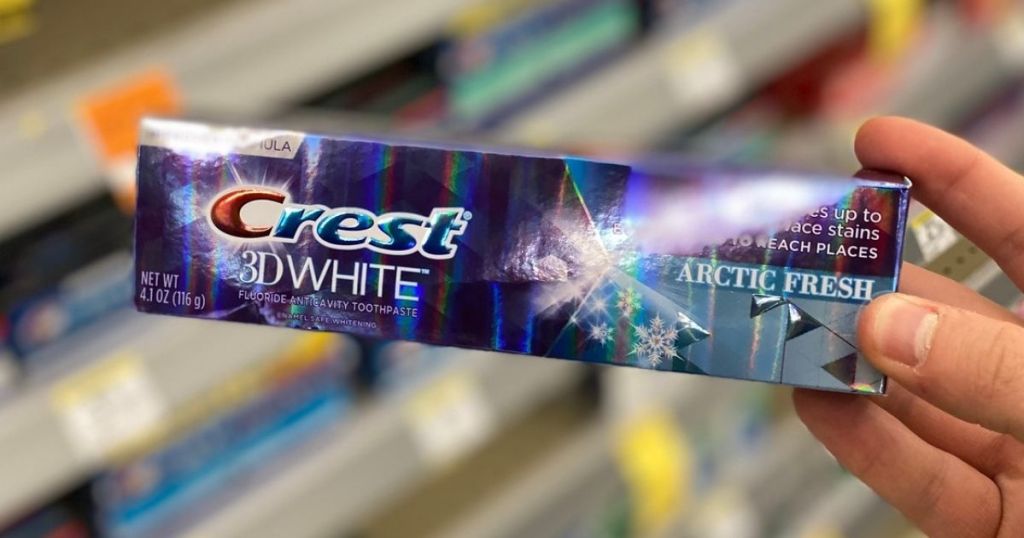 Crest Toothpaste in man's hand