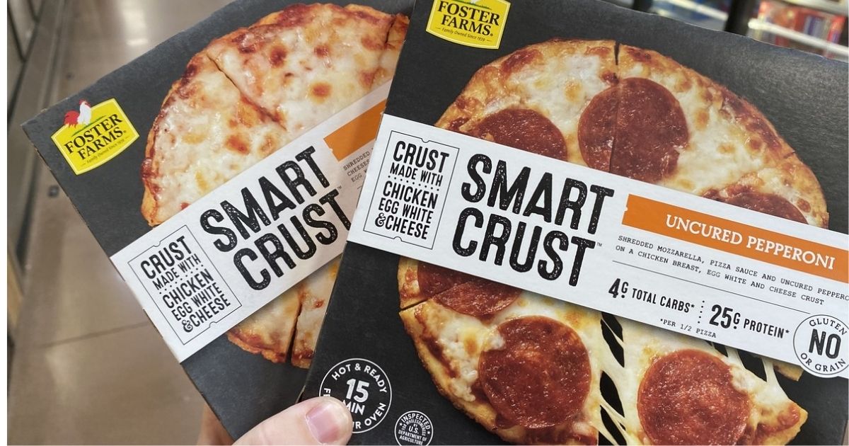 hand holding 2 Foster Farms Smart Crust Pizzas in store