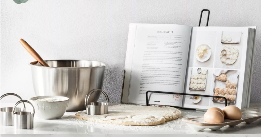 metal serving bowls on counter with book open