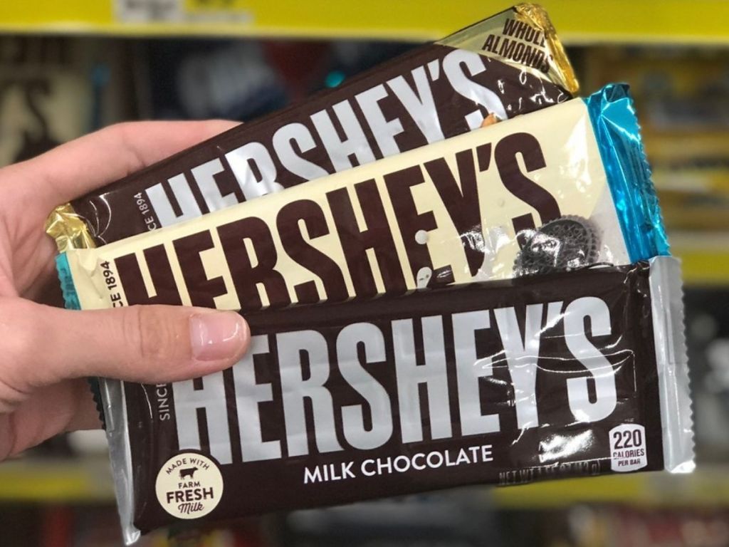 3 Hershey's chocolate bars in woman's hand