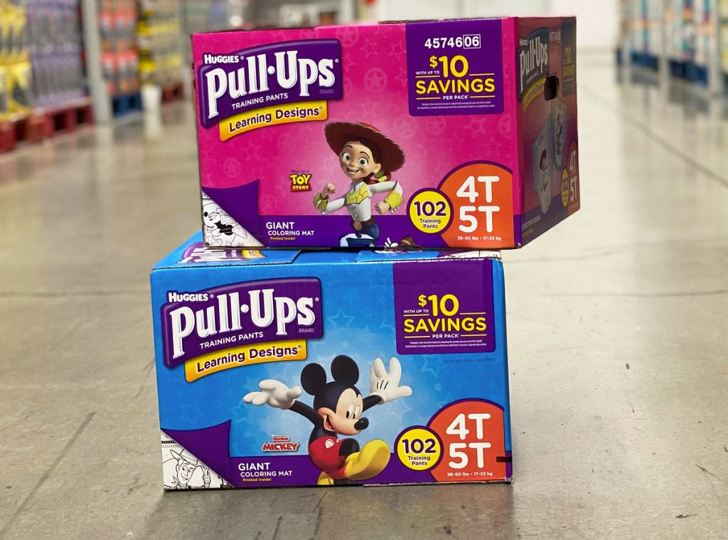 two boxes of huggies pull ups stacked on each other on floor of sam's club