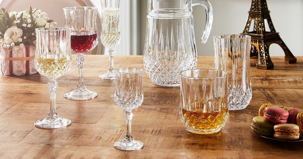 various pieces of crystal glassware on wood table