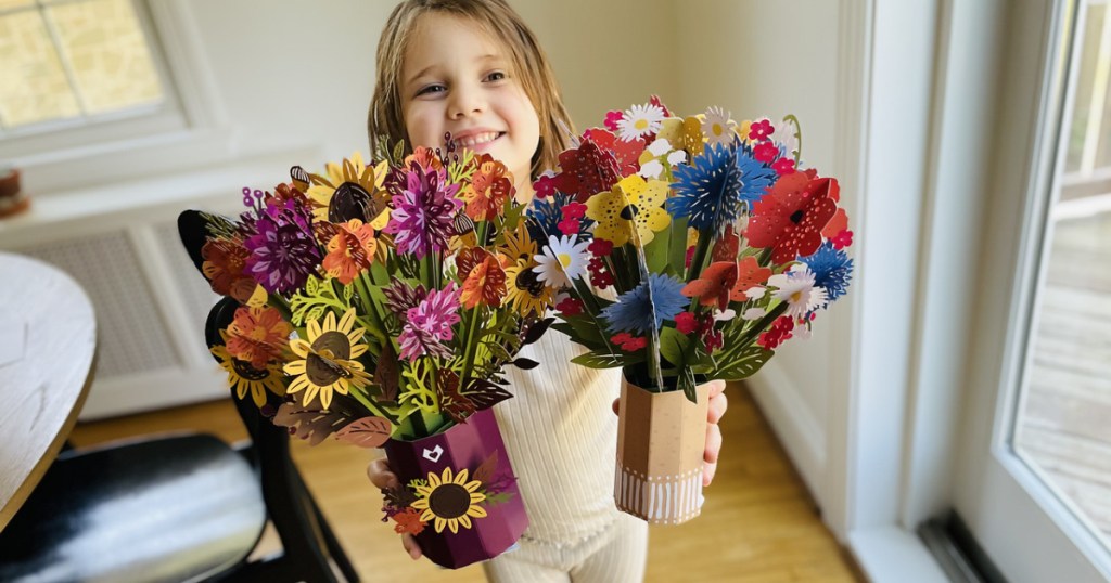 little girl holding pop up cards