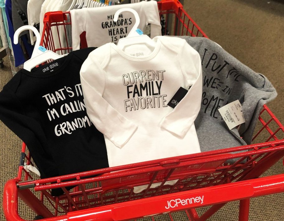 multiple baby bodysuits in a red jcpenney shopping cart