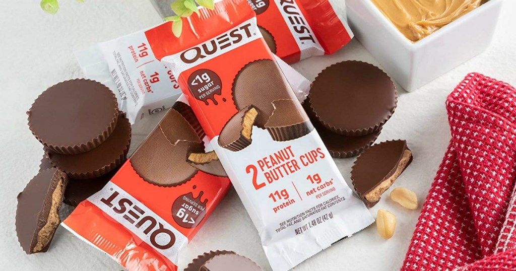 Quest brand peanut butter cups in packaging in a pile