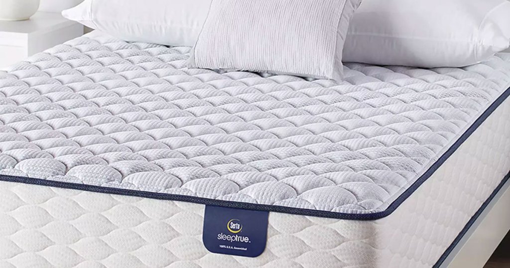 white and light blue serta mattress with pillows on top