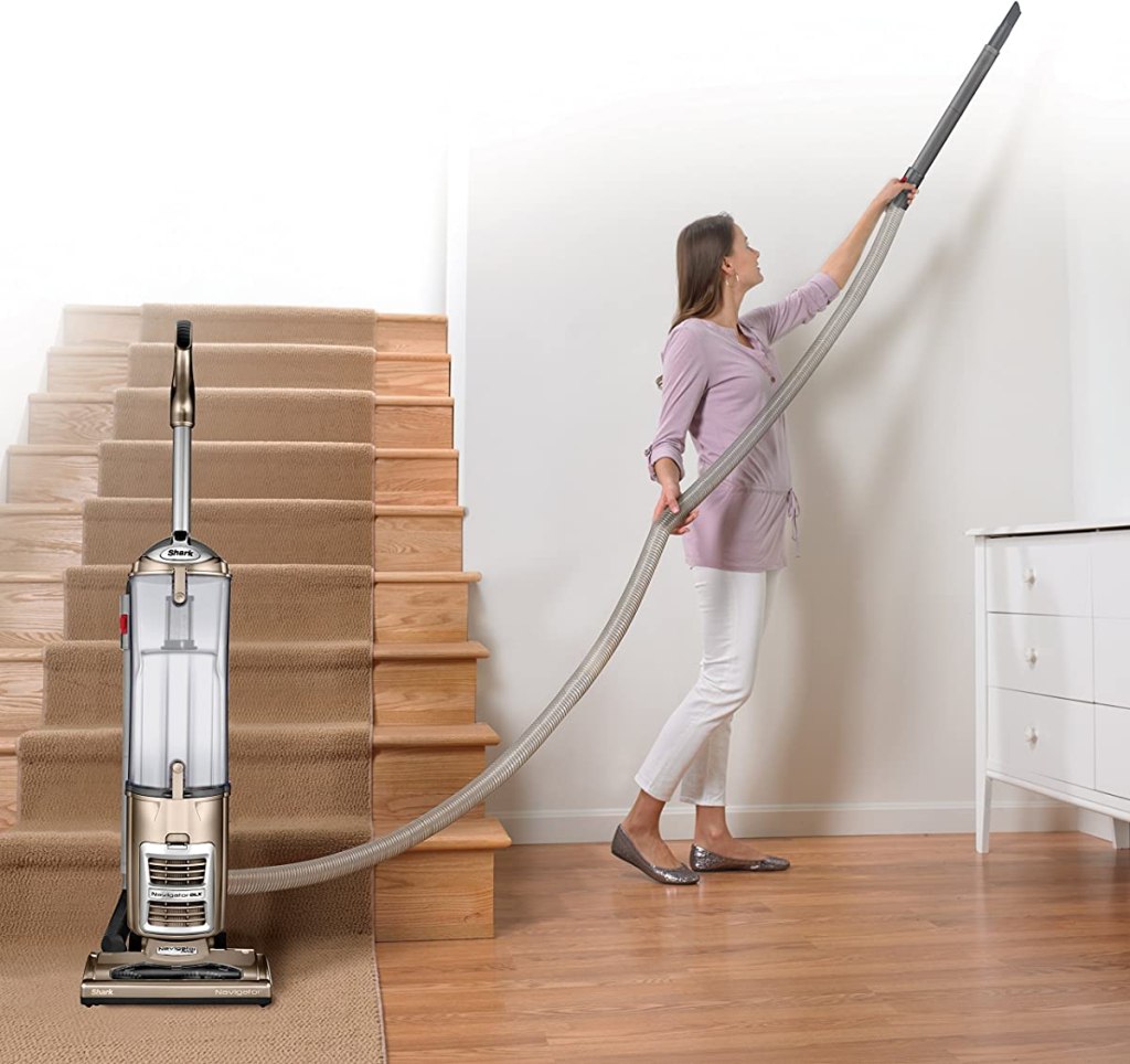 woman vacuuming the ceiling