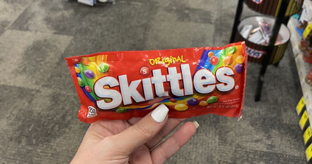 hand holding skittles 