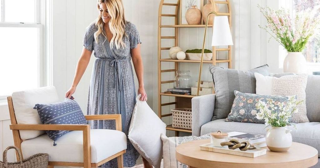 woman putting a pillow on a chair