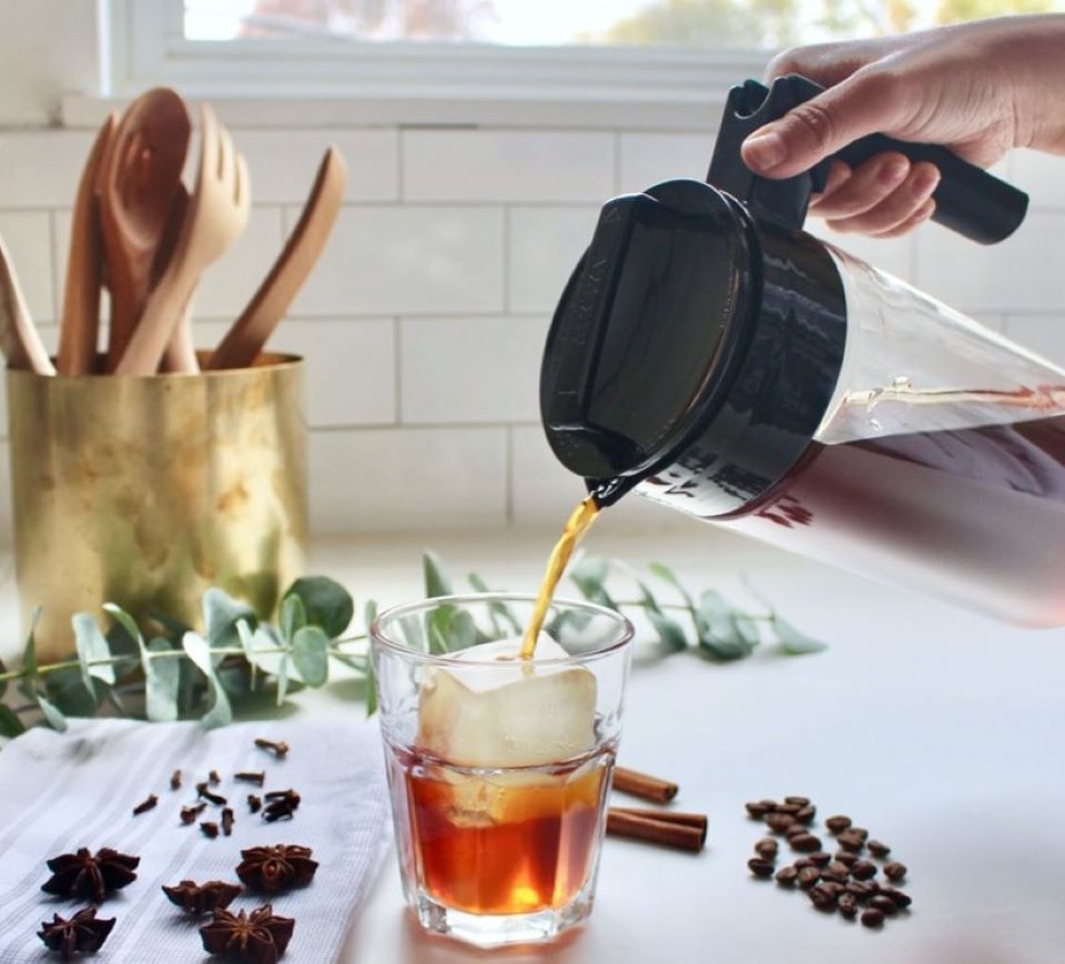 hand pouring coffee into a cup