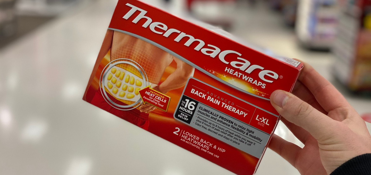 hand holding a box of Thermacare Wraps in a store