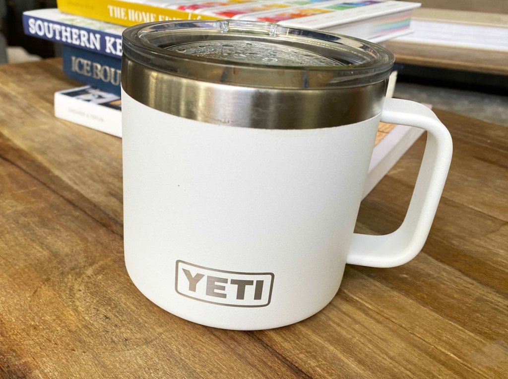 white yeti rambler mug on a wood table