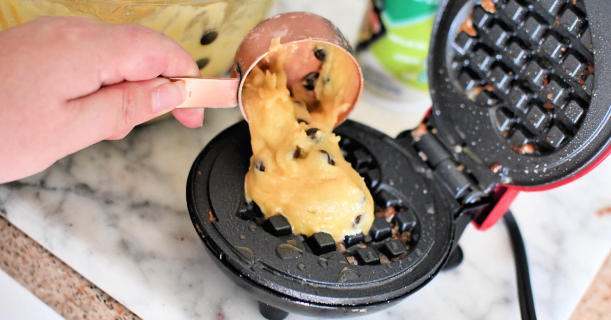 adding batter to dash waffle maker for cookie waffles 