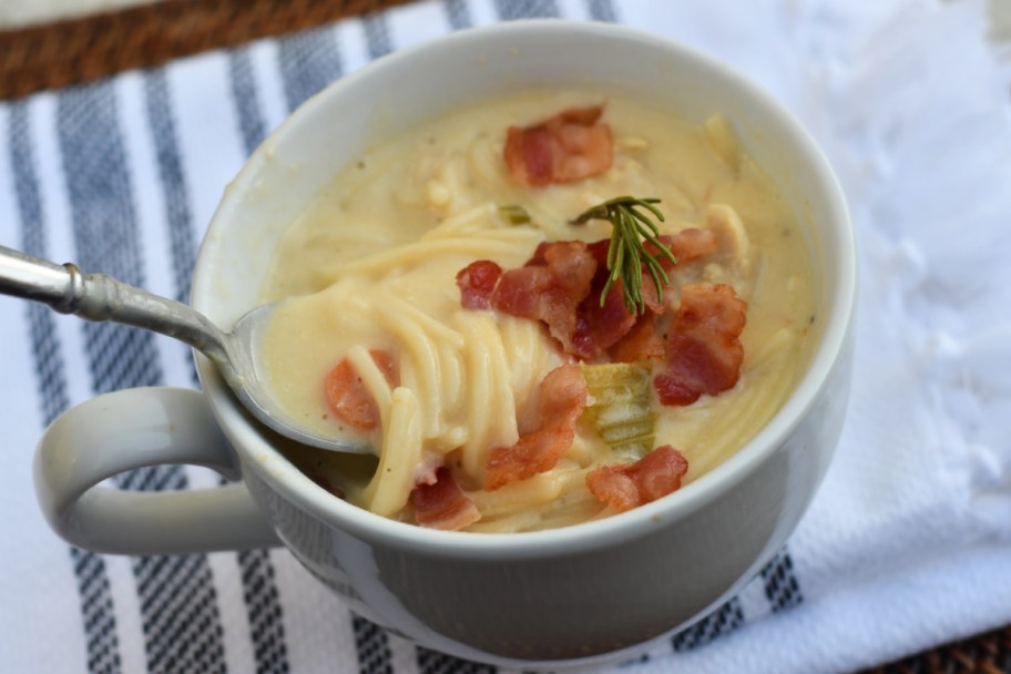 A cheesy chicken noodle soup recipe made with cream cheese and placed in a bowl 