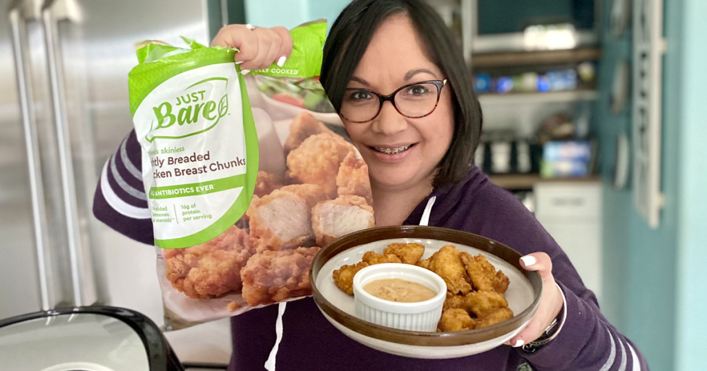 woman holding Just Bare chicken nuggets 