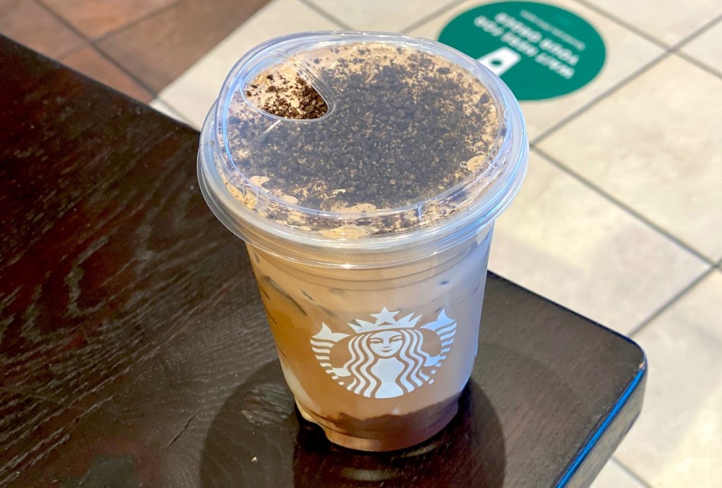 iced starbucks drink sitting on corner of table