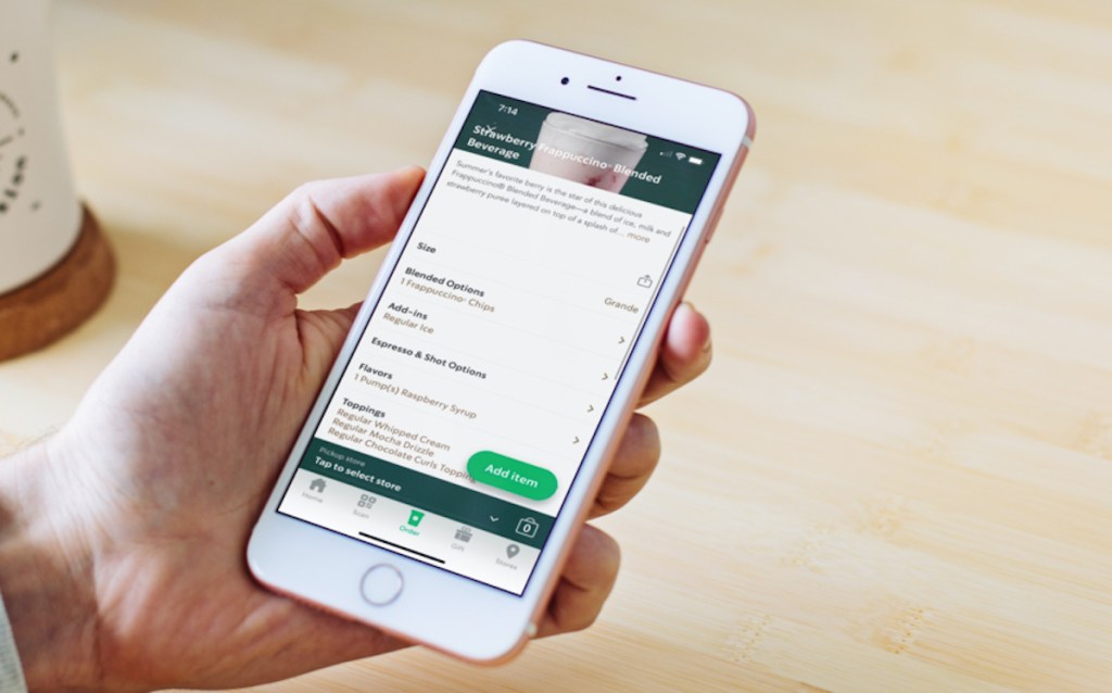hand holding phone with starbucks love bug drink on order screen