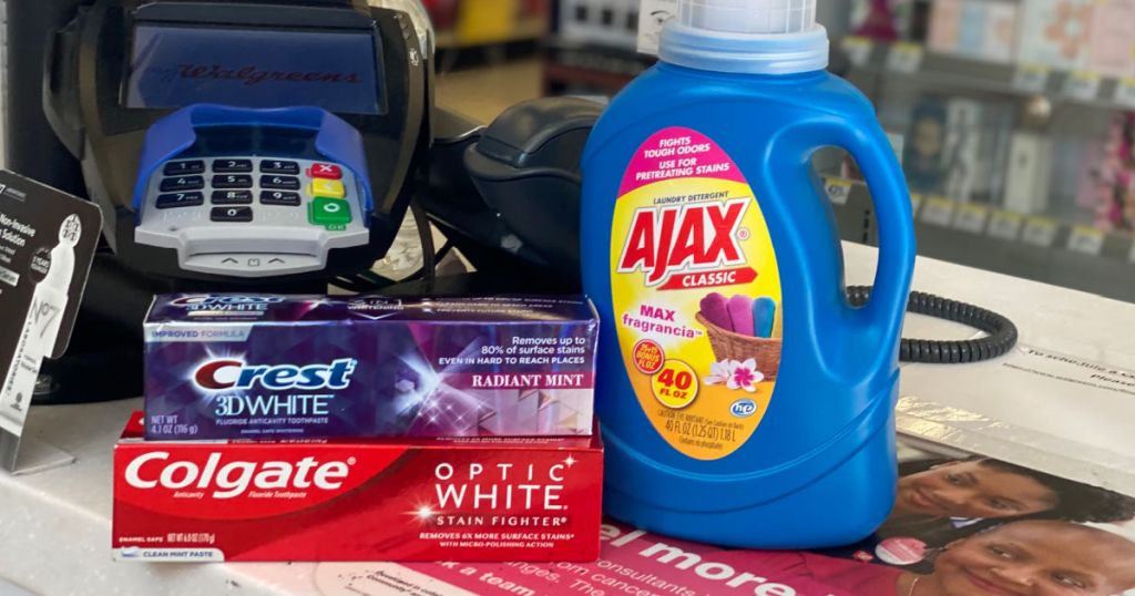 two tubes of toothpaste and laundry detergent on shelf