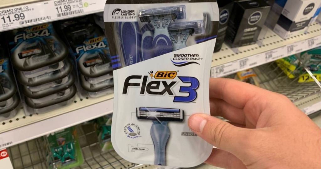 hand holding BIC Flex 3 Men's Disposable Razors in store