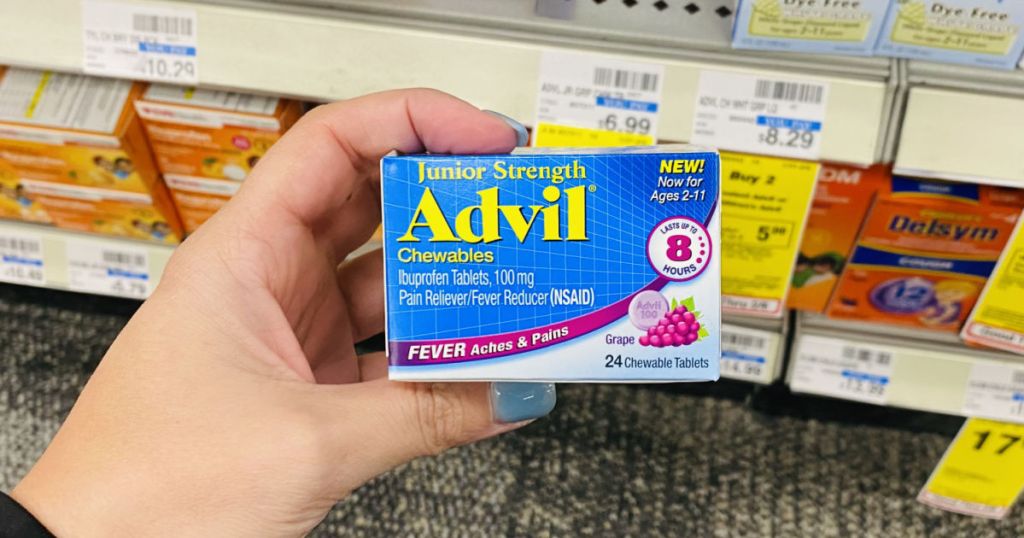 hand holding blue box of advil 