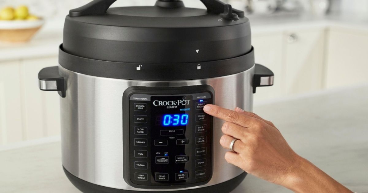 hand pressing a button on a Crock-Pot Multicooker