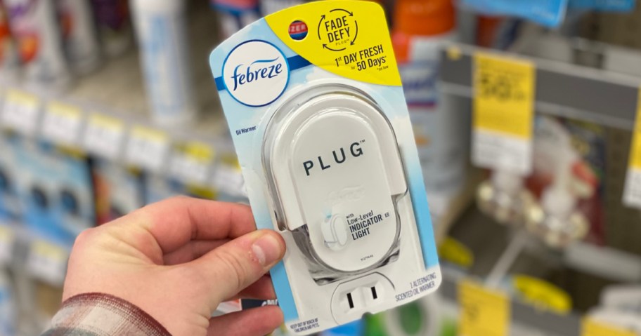 hand holding a febreze plug-in warmer at walgreens