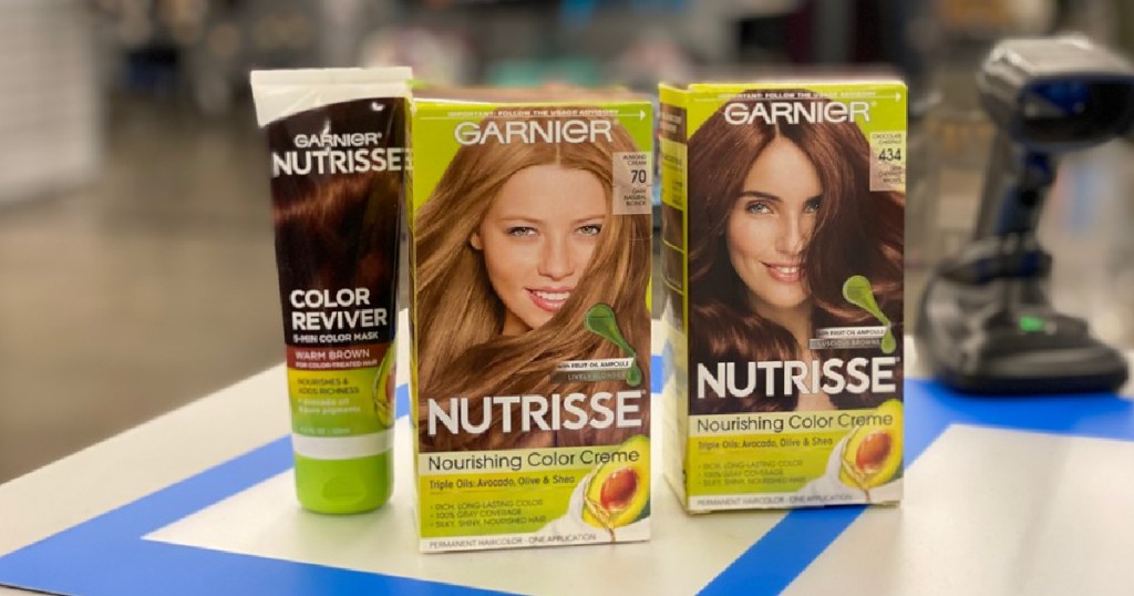 two boxes of hair dye and tube of hair mask on store counter