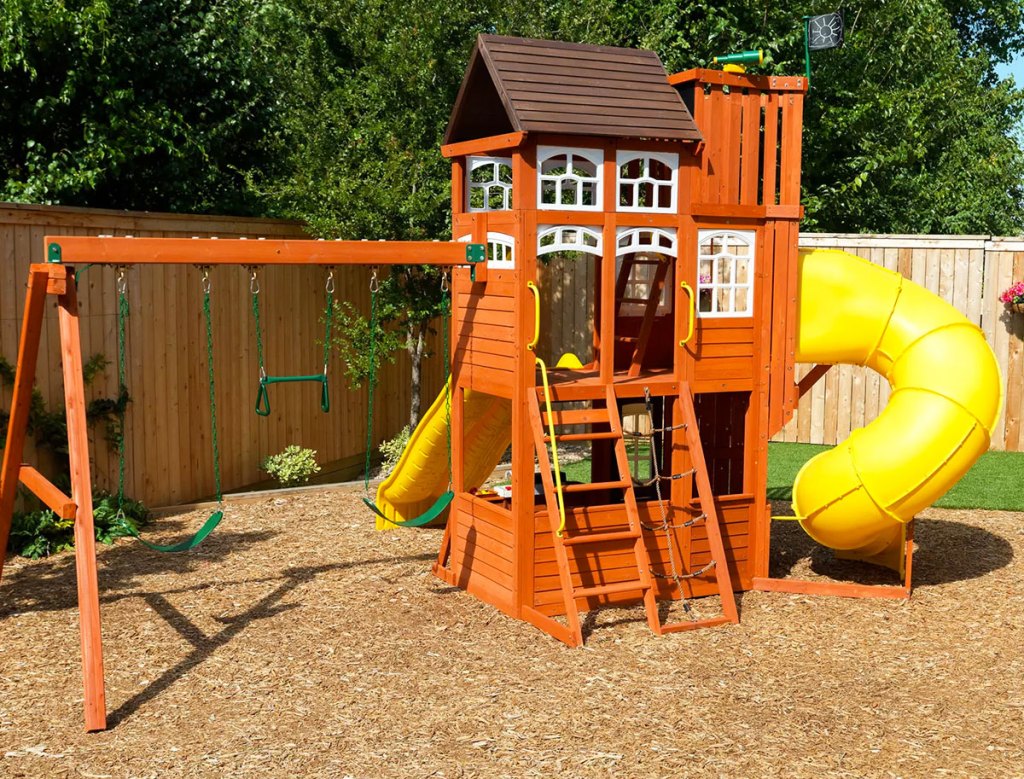 wooden backyard playset with swings and lookout tower