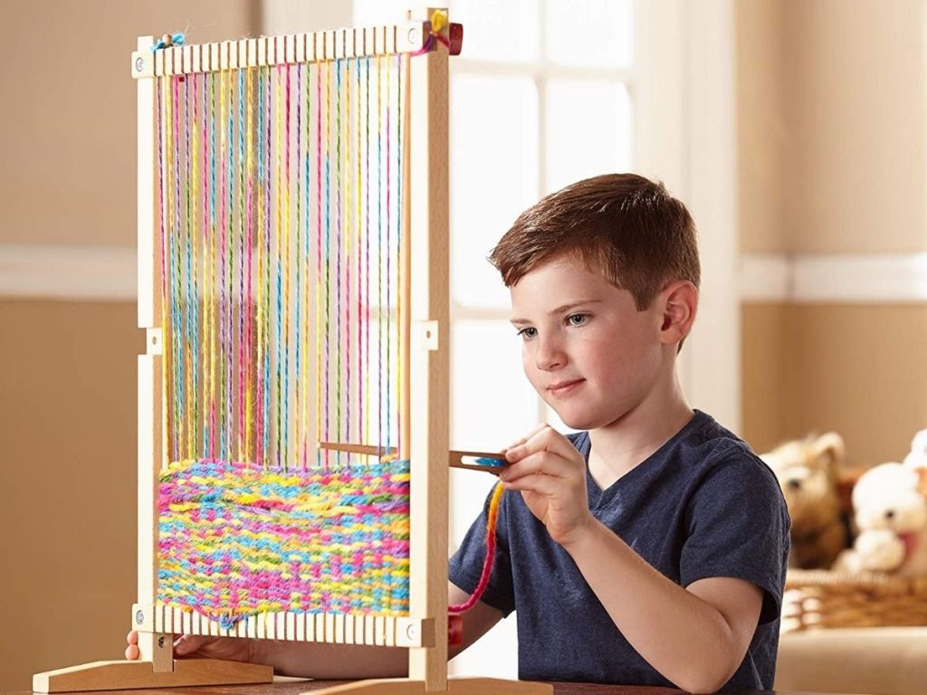 boy using Melissa & Doug Loom Kit