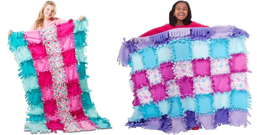 Girls holding Melissa & Doug Tied Quilt Sets