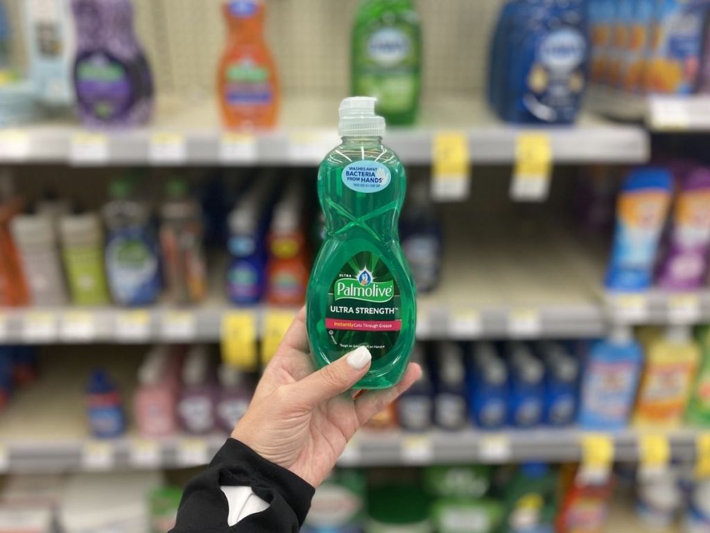 hand holding green container of soap 