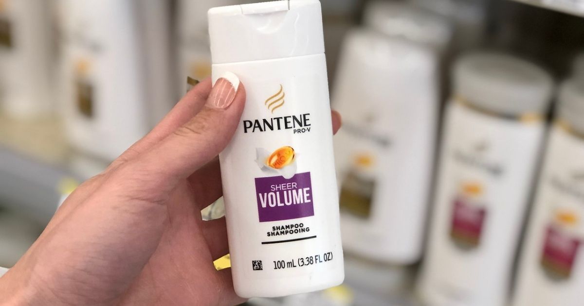 Woman holding small bottle of Pantene