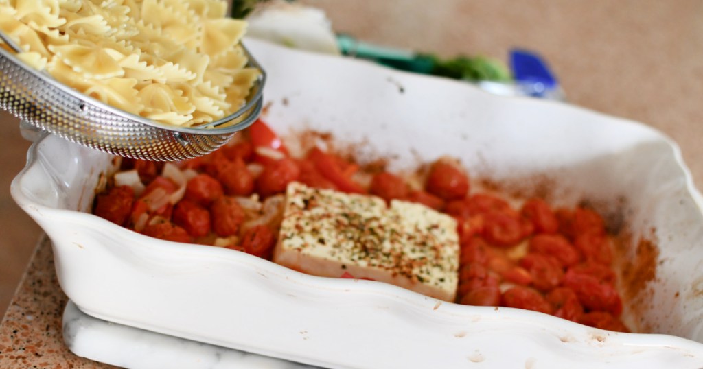 adding noodles into baked feta pasta