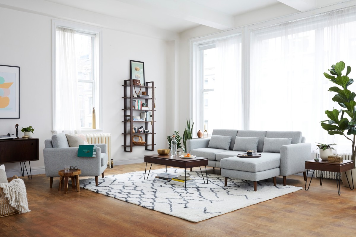 living room with white walls, tall windows, and hardwood flooring