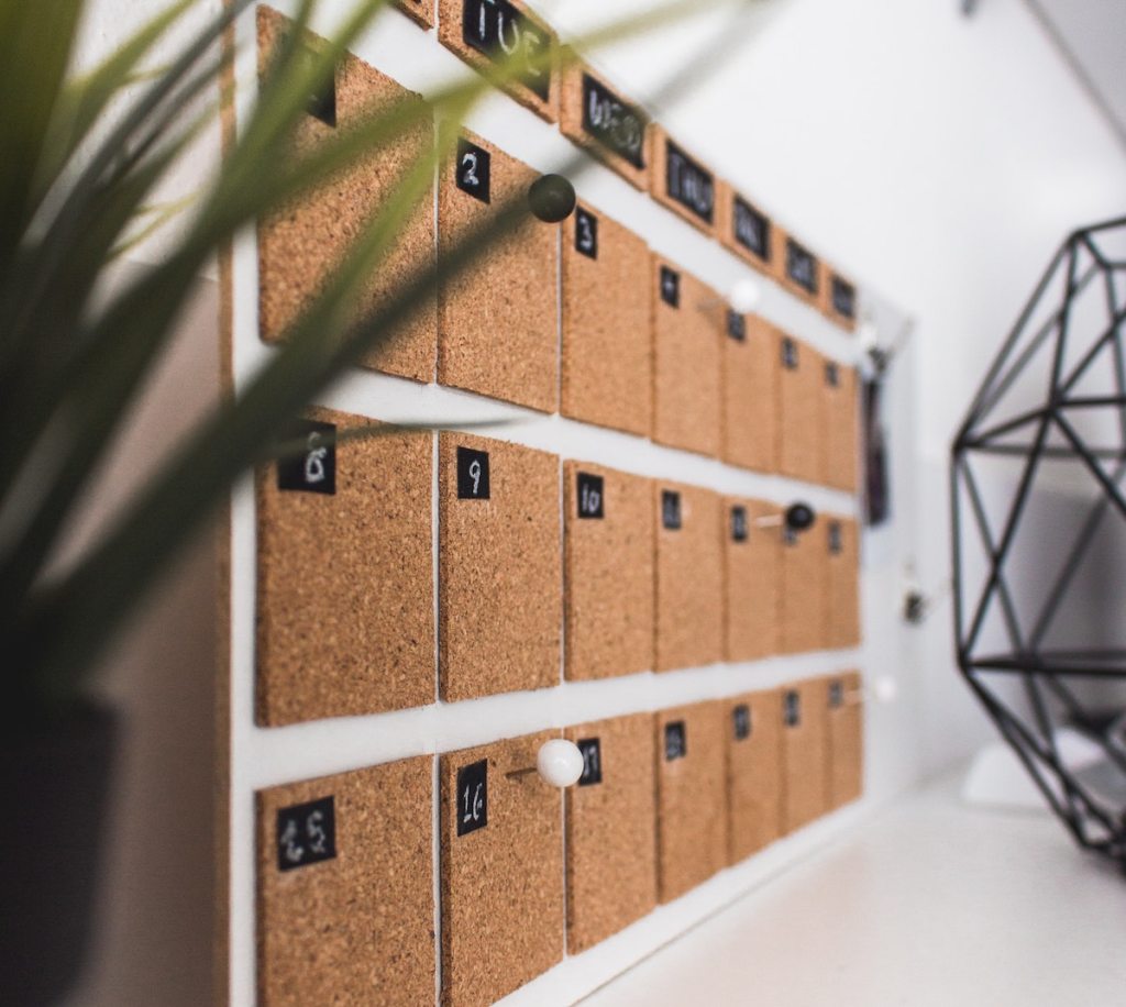 close up of cork calendar with white pin 