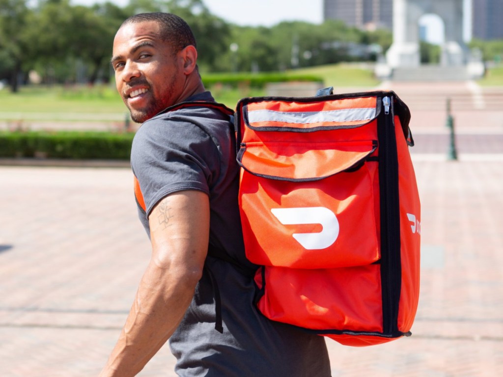 man with red backpack on outside