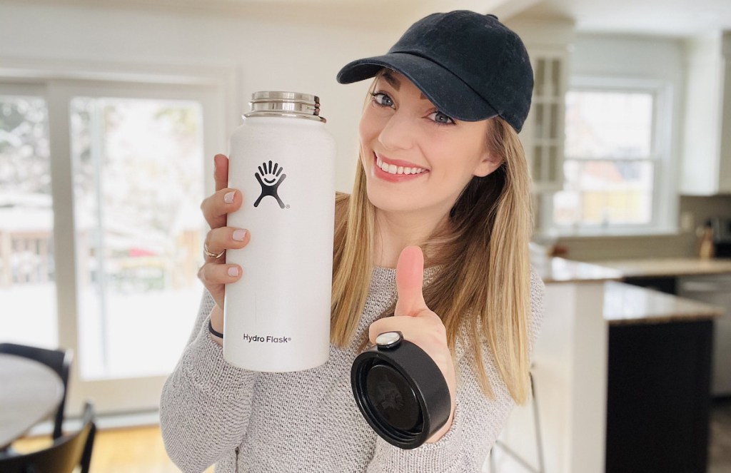 woman holding white hydro flask bottle