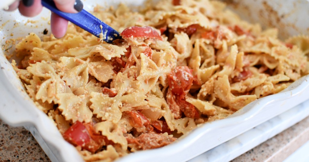 stirring melted feta bow tie pasta