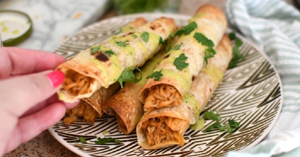 taquitos filled with shredded chicken on plate 